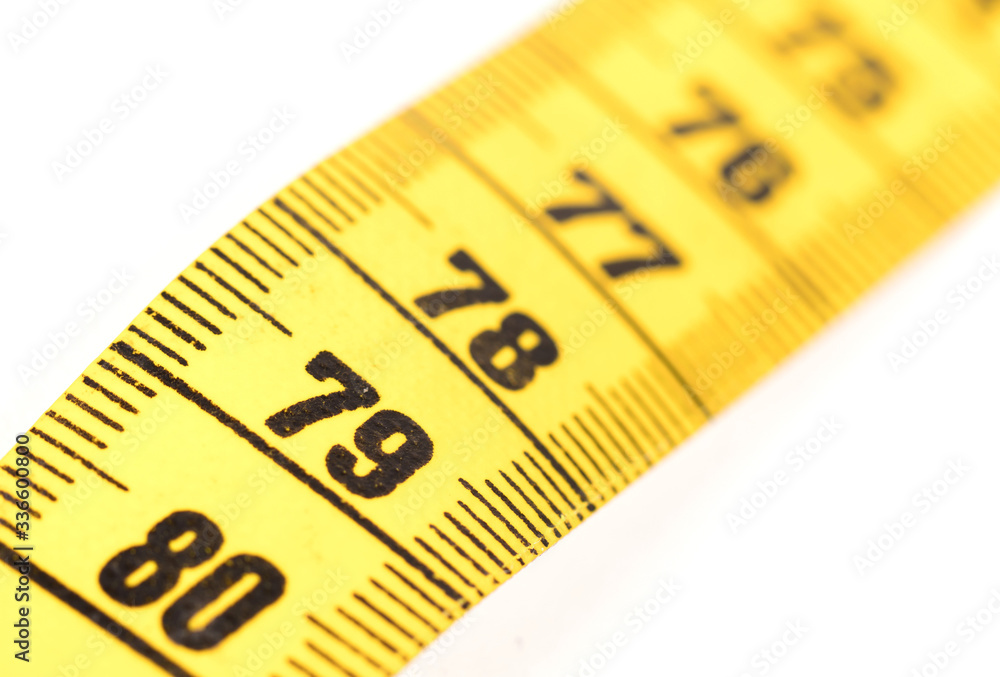 Close-up of a yellow measuring tape isolated on white - 79 Close-up of a yellow measuring tape isolated on white - 79