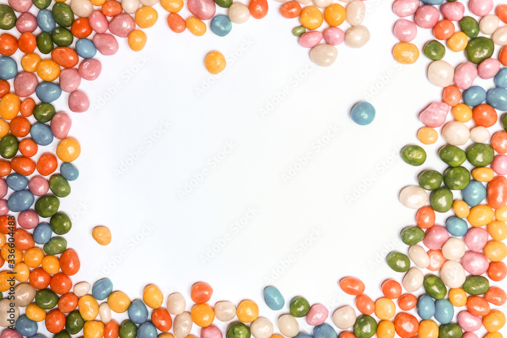 assorted bean candies making a frame with white copy space inside