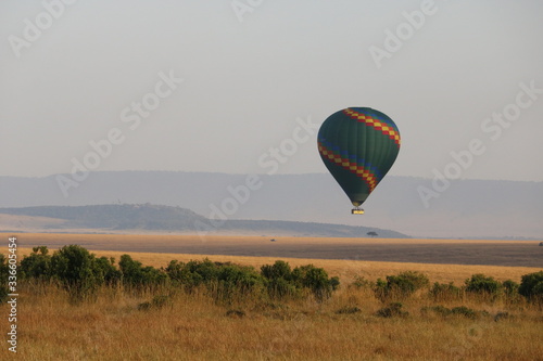hot air balloon soaring in the skies of mara. © naturespy