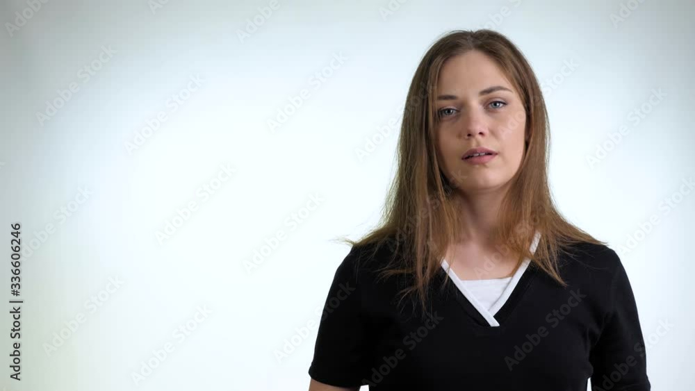 Young woman takes off medical mask. Female breathes deeply and looking at camera. Isolated on white background. Coronavirus pandemic epidemic is over. End of quarantine and self-isolation. Young woman takes off medical mask. Female breathes deeply and looking at camera. Isolated on white background. Coronavirus pandemic epidemic is over. End of quarantine and self-isolation.