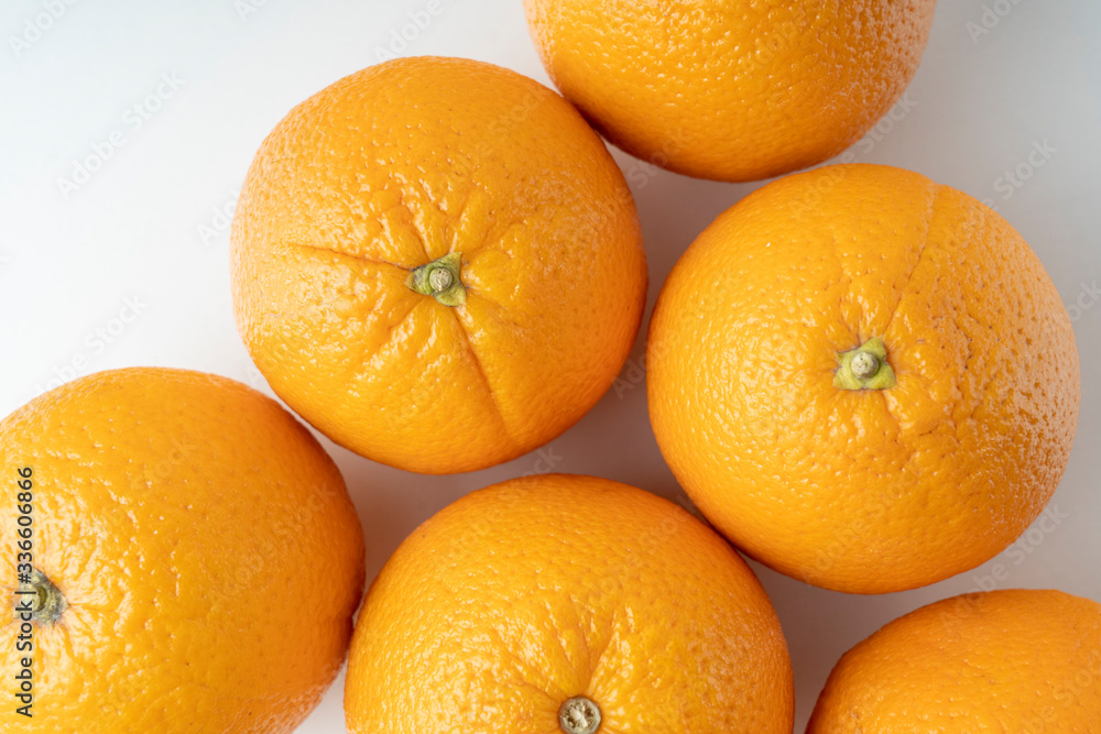 fresh oranges on a white background close up fresh oranges on a white background close up