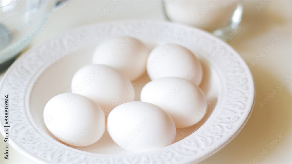 white chicken eggs in a plate on a white background
white chicken eggs in a plate on a white background