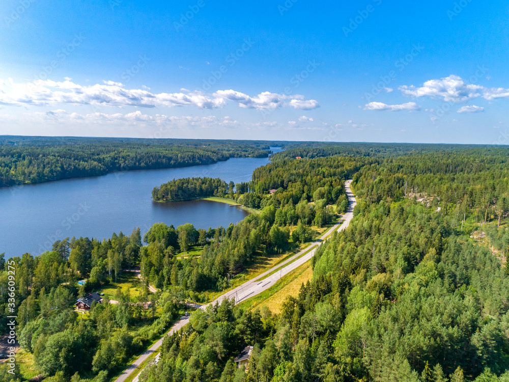 Aerial view of blue lakes and green forests in Finland. 