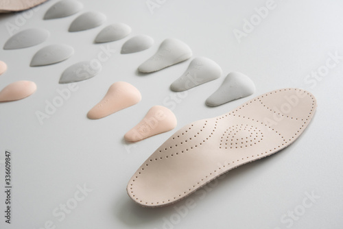 The process of manufacturing individual orthopedic insoles for people with foot diseases, flat feet. Close-up of the insole and accessories for it. photo