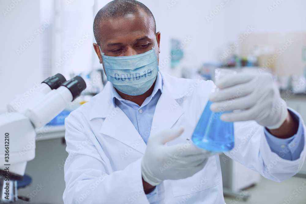Professional lab worker wearing a medical mask Professional lab worker wearing a medical mask