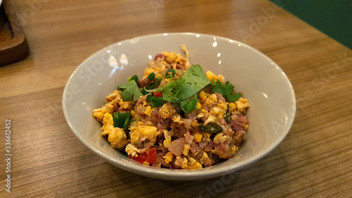 Northern Thai style Stir Fried Sour Pork with Egg serving on small bowl on timber table