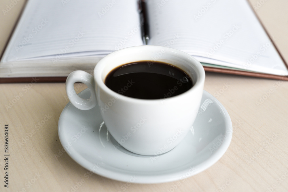 Coffee Cup on Office Table. Daily Planner. Business Concept Coffee Cup on Office Table. Daily Planner. Business Concept
