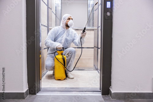 Sanitizing interior surfaces. Cleaning and Disinfection inside buildings, the coronavirus epidemic. Professional teams for disinfection efforts. Infection prevention and control of epidemic. photo
