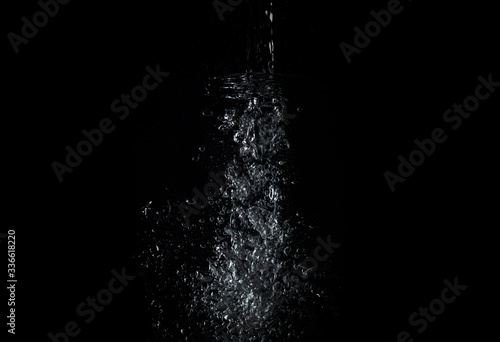 Water Splashes in different directions on a black background