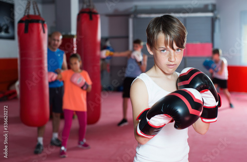 Boxer in gloves posing during boxing practicing