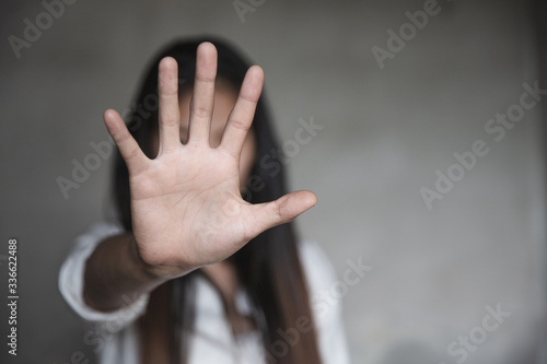 woman raised her hand for dissuade, Abuse, campaign stop violence against women. Stop sexual harassment and rape. photo