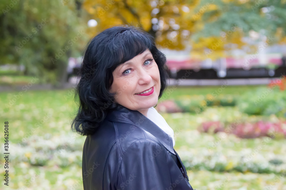 Portrait of a beautiful middle-aged woman.Beautiful elderly woman in the fall. Autumn age. Portrait of a beautiful middle-aged woman.Beautiful elderly woman in the fall. Autumn age.