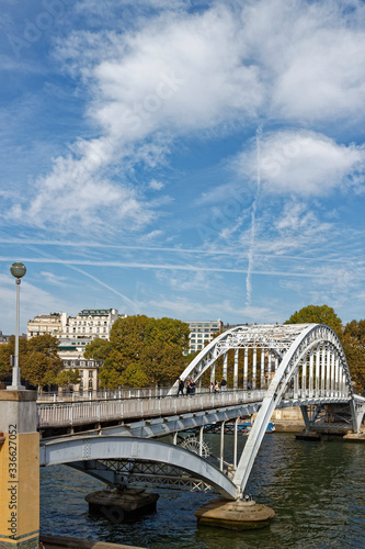 The Debilly Footbridge with People on it, with its single Cast Iron Arch spanning the River Seine in Central Paris. photo