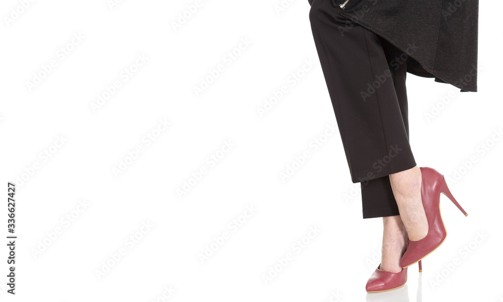 career women's feet with high heels on a white background career women's feet with high heels on a white background