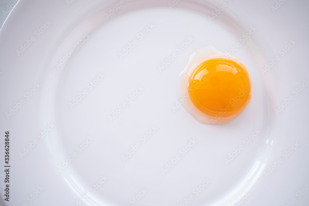 Egg yolk on a white plate Egg yolk on a white plate