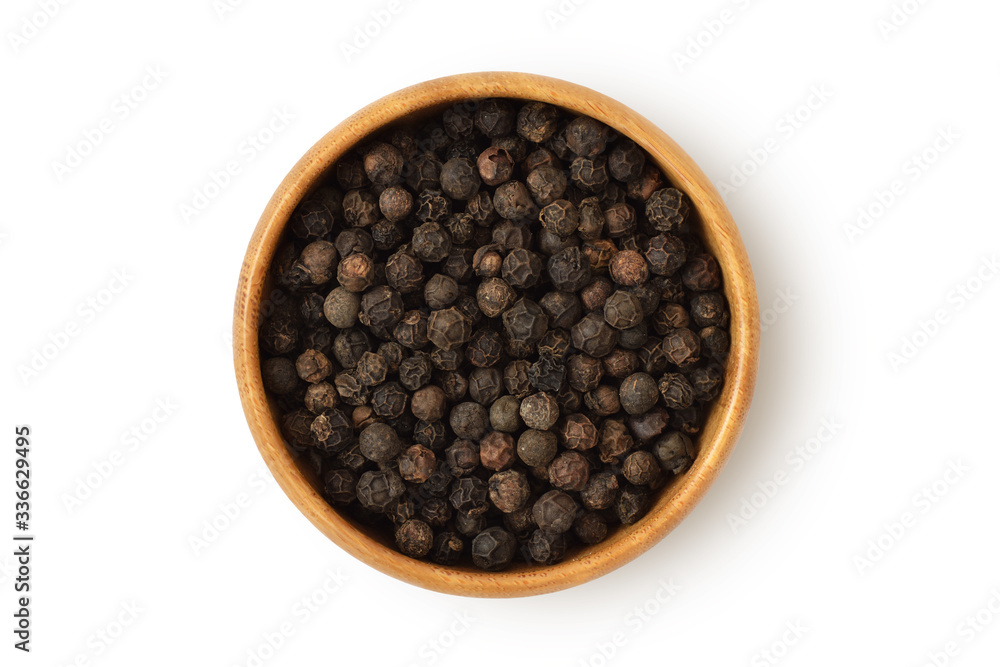 Black pepper in wooden bowl on white background Black pepper in wooden bowl on white background