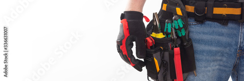 Canvas Print Electrician or professional Builder in an installer's belt with tools on a white background