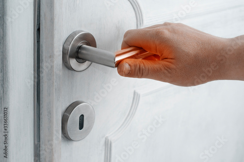 Photography Coronavirus safety tips concept: man open a door with a contaminated handle without protection