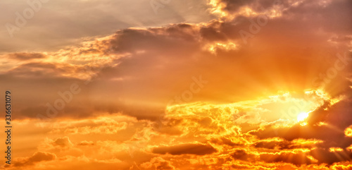 scenic sunrise sky landscape background natural color of morning cloudscape panorama with sun behind clouds wide panoramic view Orange sunlight of sunset nature