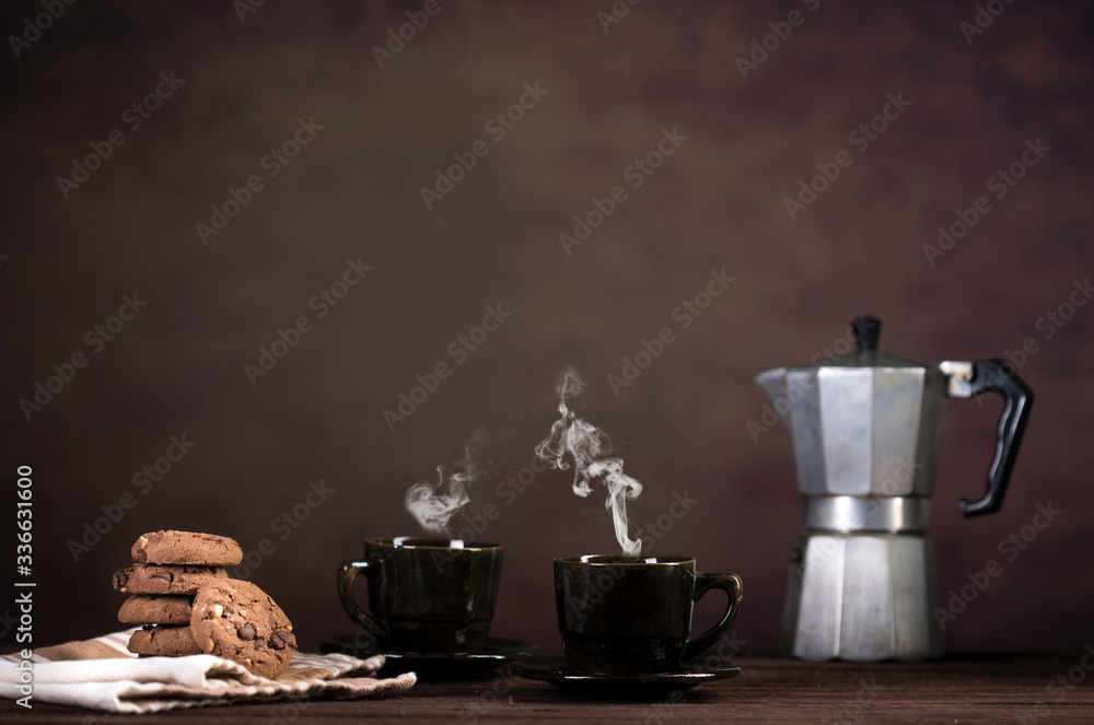 Coffee, cookies and utensils for coffee maker on dark brown background with copy space for text Coffee, cookies and utensils for coffee maker on dark brown background with copy space for text