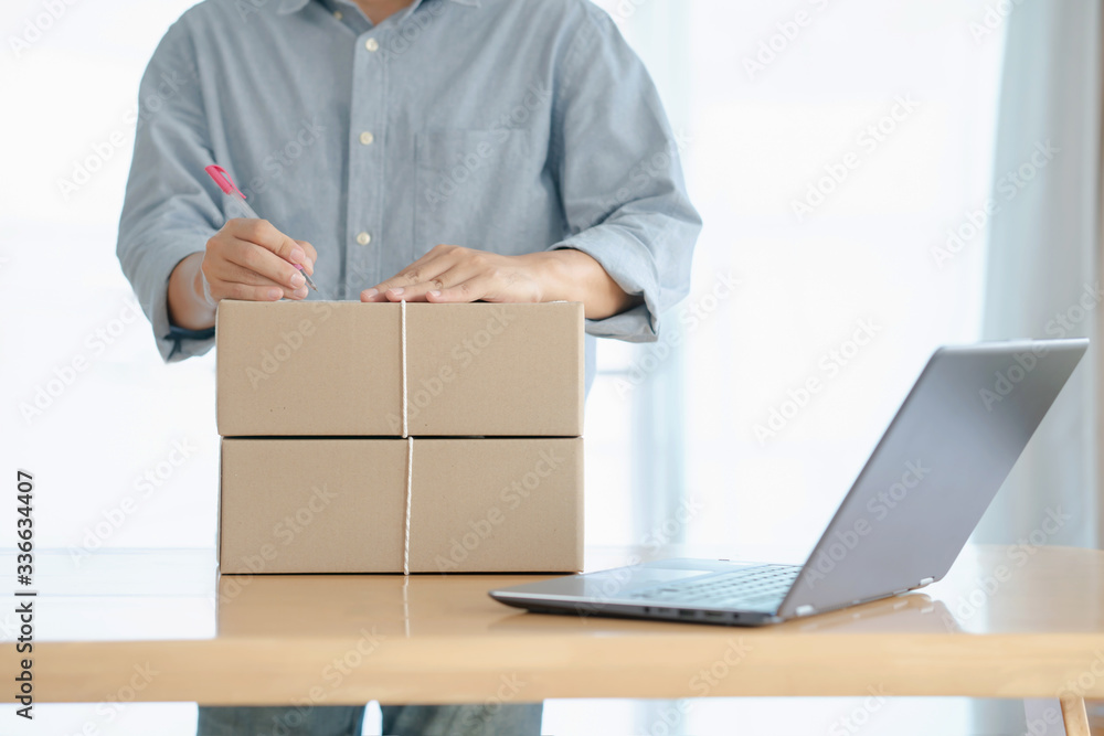 Online shopping young start small business in a cardboard box at work. The seller prepares the delivery box for the customer, online sales, or e commerce. Online shopping young start small business in a cardboard box at work. The seller prepares the delivery box for the customer, online sales, or e commerce.
