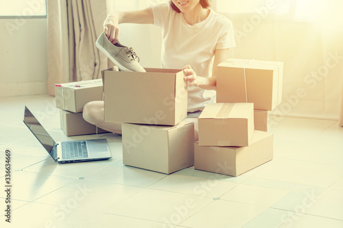 Happy young businessman owner packing shoes to cardboard box, Young Owner Woman Start up for Business Online. © photobuay