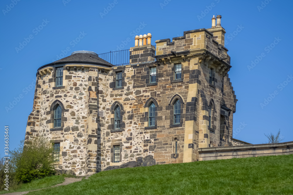 View of a classic stone monument house on Calton Hill, blue sky as background