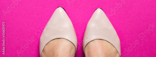 Pair of female shoes with toes on pink background. free copy space. Overhead shot of elegant shoes. Banner. Concept of fashion.