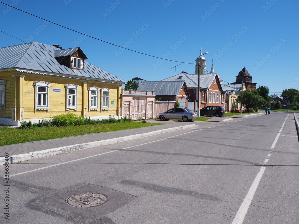 a road without cars passes through a settlement in Russia