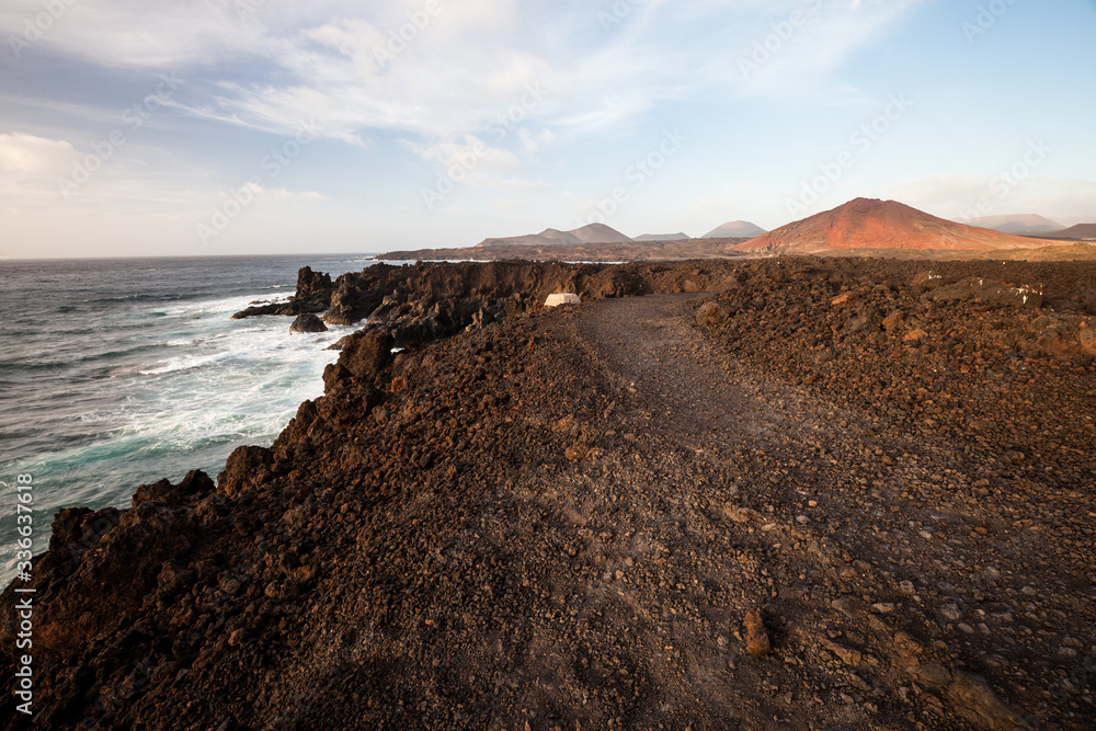 Los Hervideros, coastline in Lanzarote with waves and volcano