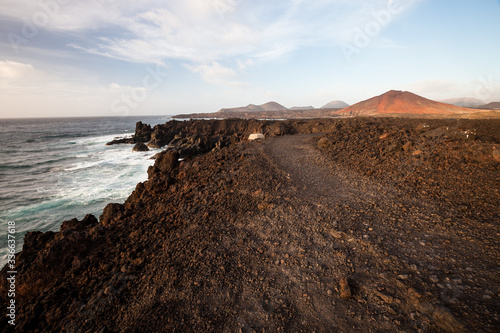 Los Hervideros, coastline in Lanzarote with waves and volcano
