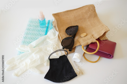 Shopping bag with necessary items  reusable mask, spray alcohol and sanitizer hand gel, gloves, eyeglasses, zip lock bag for hygiene, cleaning and protect from Covid-19. Coronavirus concept.