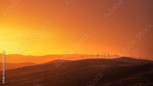 Windmills in an incredible orange sunset panorama. 