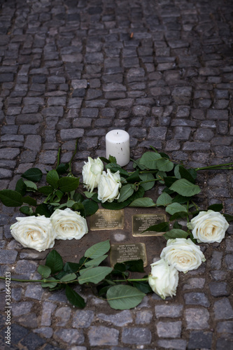 Stolpersteine (stumbling stone) with roses	