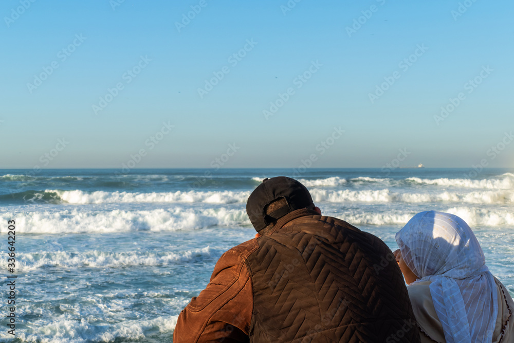 Man and woman watching the sea