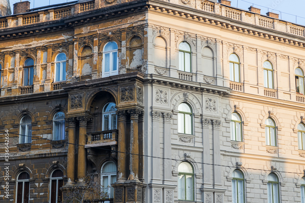Contrast on the building in Budapest - one part of the house is renewed, the other is old and ugly Contrast on the building in Budapest - one part of the house is renewed, the other is old and ugly