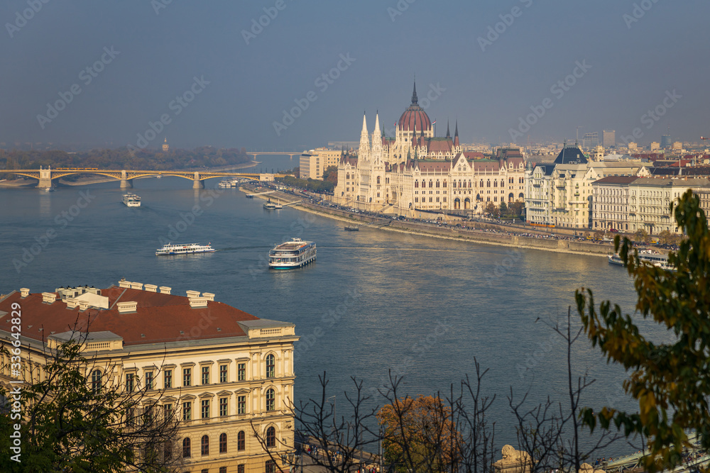 Hungarian Parliament building aerial view and wide Danube river with cruise boats