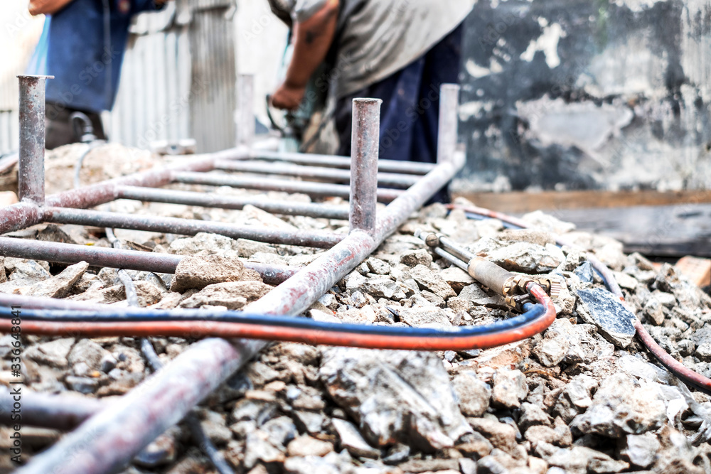 Obraz premium Oxy Acetylene Oxy-fuel welding and cutting head tool on the ground at construction site.