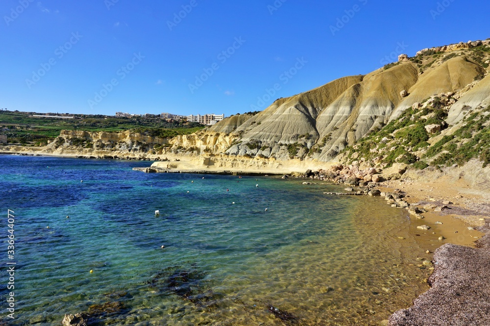 Xatt L-Ahmar - stony seaside with characteristic  sandstone cliffs and crystal blue water. Ideal place for picnic or sunbathing, diving, snorkelling and swimming far away from crowdy beaches.
