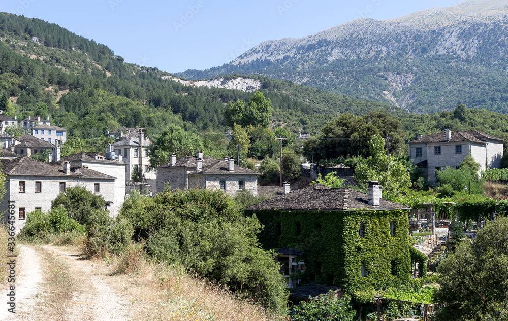 View of the village in the mountains on a sunny day (village Papigo, Epirus region, Greece).