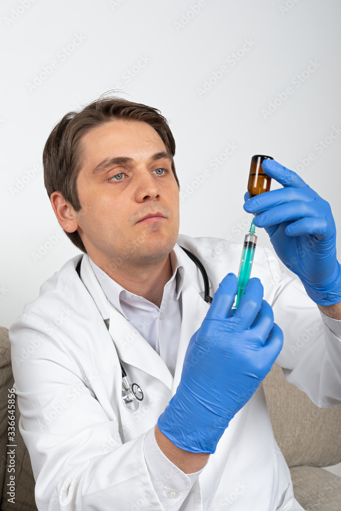 Doctor holding liquid medication and syringe Doctor holding liquid medication and syringe