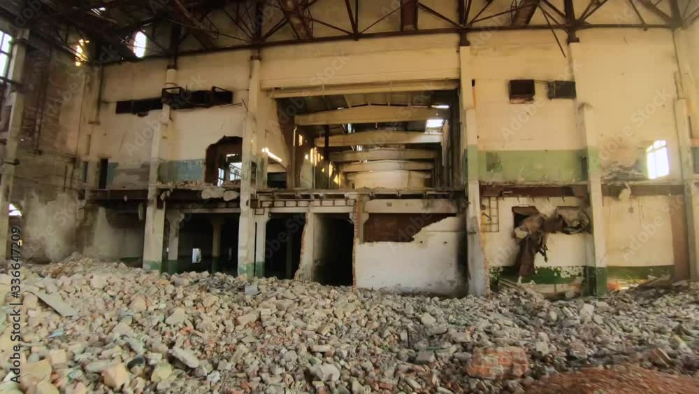 FPV drone flies quickly and maneuverable through an abandoned construction at sunset FPV drone flies quickly and maneuverable through an abandoned construction at sunset