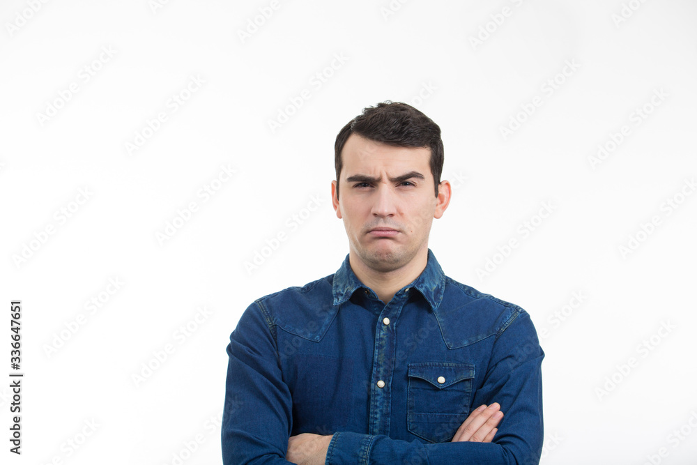 Angry serious man looking to camera with crossed hands over white background. Angry serious man looking to camera with crossed hands over white background.