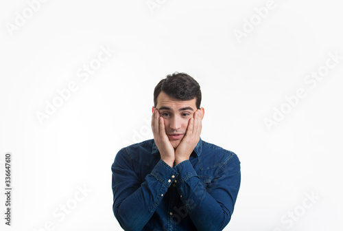 Nervous young man over white background. Stressed young man having problems.