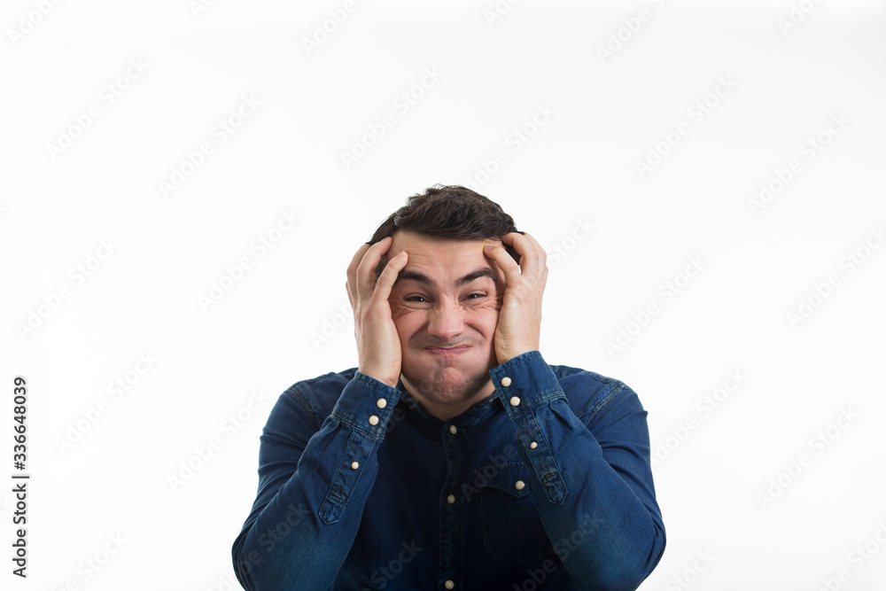 Nervous man holding hands inon his head about to have nervous atomic breakdown isolated on white background. Human expression concept. Nervous man holding hands inon his head about to have nervous atomic breakdown isolated on white background. Human expression concept.