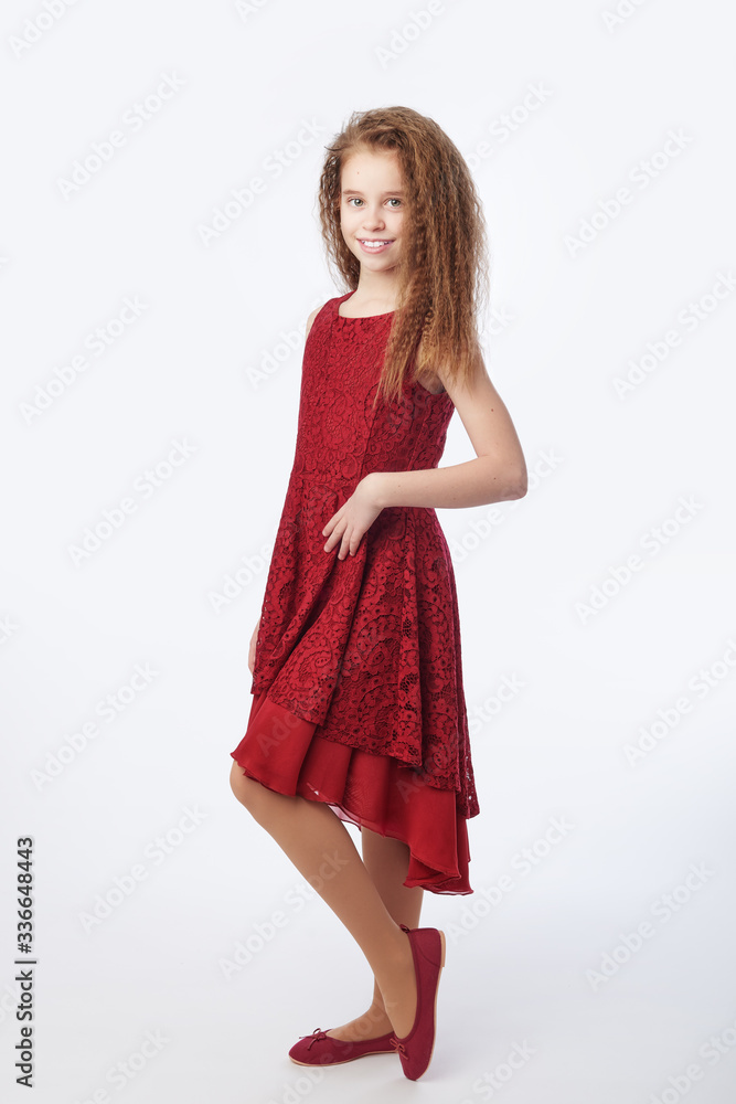 Young girl wearing red guipure dress staying on floor Young girl wearing red guipure dress staying on floor