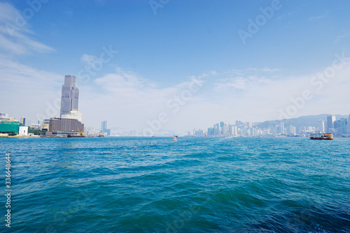 Canvas Print Central business district  Hong Kong with a clear blue sky above the harbour