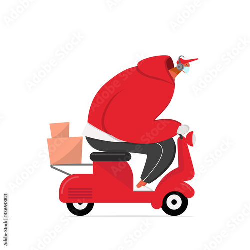 Courier in a medical mask delivers food on a scooter. Coronavirus contactless food delivery quarantine. Safe delivery during a coronavirus pandemic.