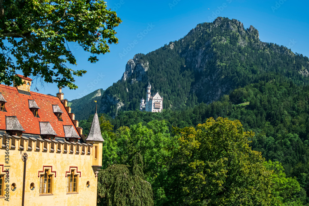 View of the two most famous castles in the area with the alps in the background. Photograph taken in Schawangau, Bavaria, Germany. View of the two most famous castles in the area with the alps in the background. Photograph taken in Schawangau, Bavaria, Germany.