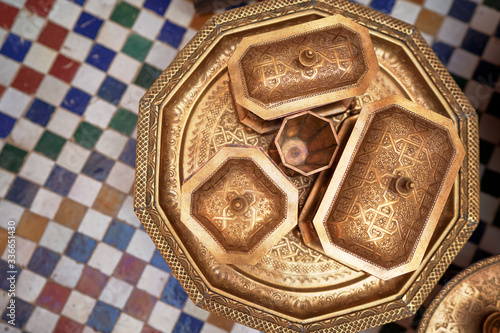 Tableau sur toile Top view on moroccan brazen tablewear with tiled background.